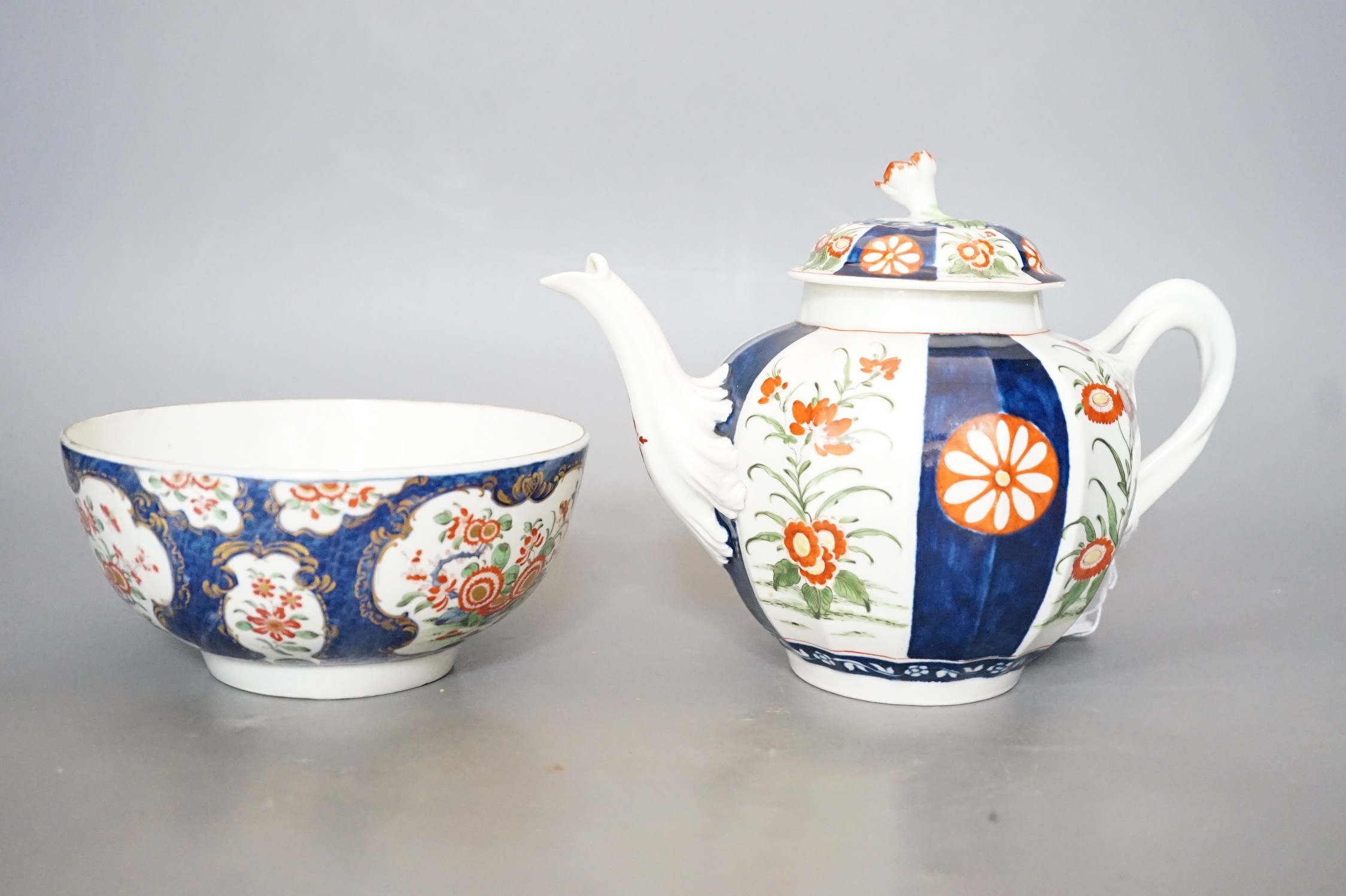 A Worcester teapot and cover, painted in the manner of the red line border group with the Queens pattern and a Worcester blue scale bowl painted with kakiemon flowers, teapot and cover 16cms high